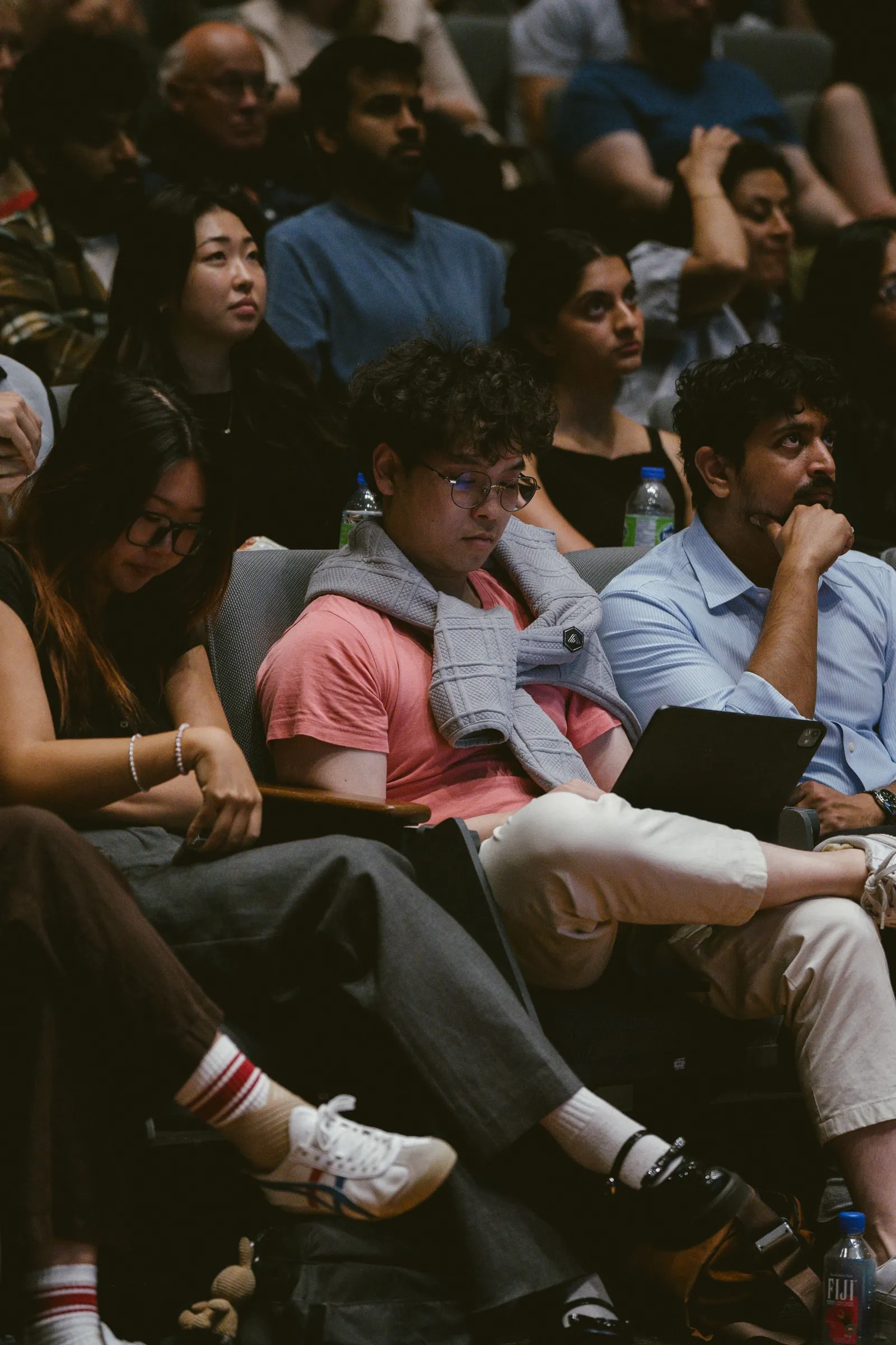 Audience members sit closely together in the Innis Town Hall seats, watching the talk attentively.